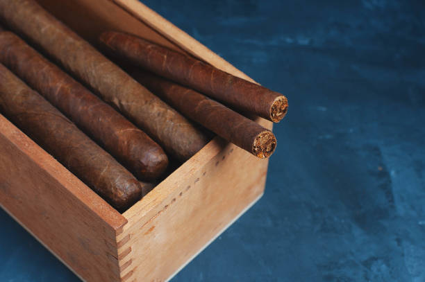 istock Cigars, Guillotine cuts off the cigar tip, black background , space for text, copy space. 1035095590