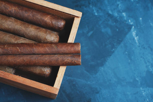 istock Cigars, Guillotine cuts off the cigar tip, black background , space for text, copy space. 1035095746