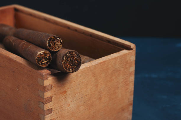 istock Cigars, Guillotine cuts off the cigar tip, black background , space for text, copy space. 1035095966