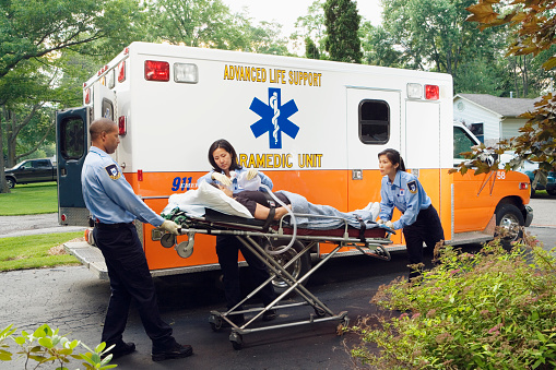 Paramedics putting woman into ambulance