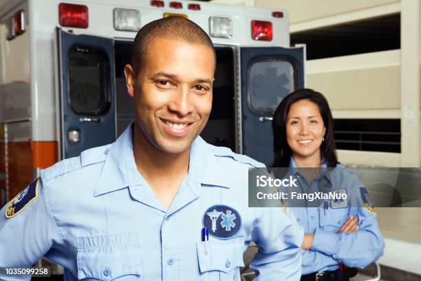 Portrait Of Paramedics In Front Of Ambulance Stock Photo - Download Image Now - Paramedic, Ambulance, Civil Servant