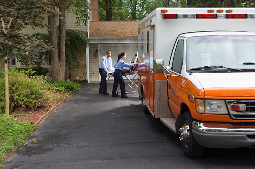 Paramedics putting person into ambulance