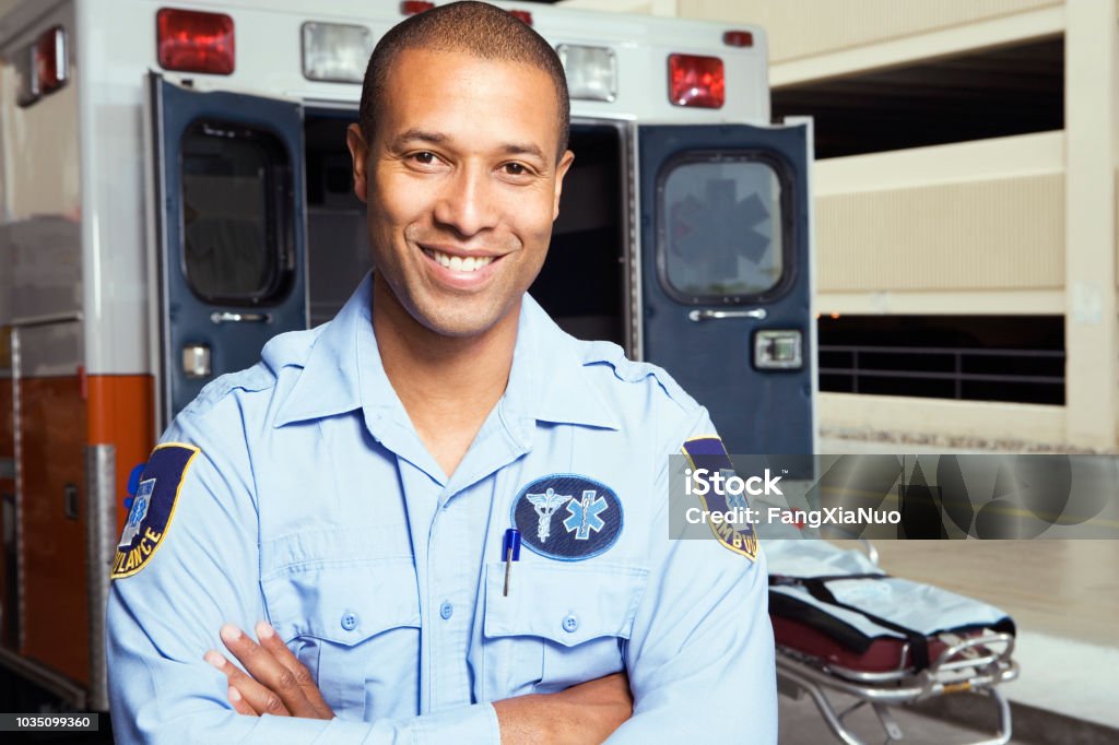Portrait of African male paramedic in front of ambulance Paramedic Stock Photo