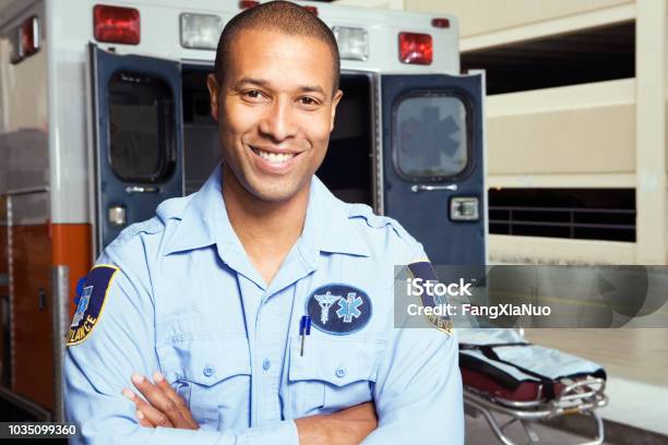 Portrait Of African Male Paramedic In Front Of Ambulance Stock Photo - Download Image Now