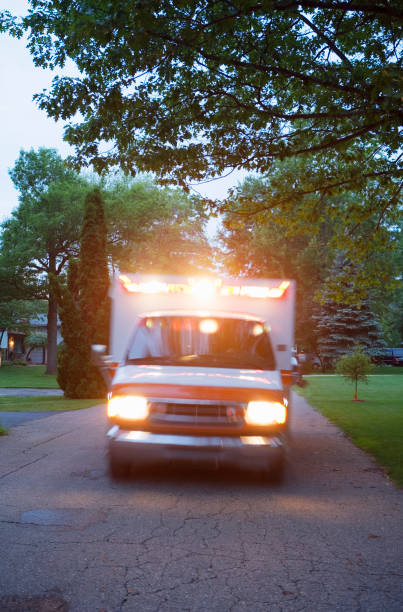 istock Ambulance with lights on in residential area 1035099406