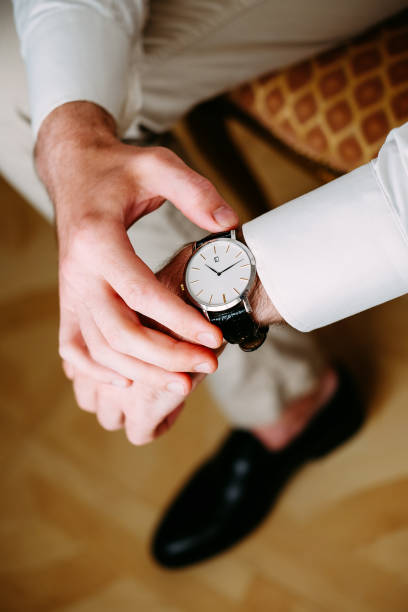 istock Handsome man checking time on his watch getting ready for the job 1035100486