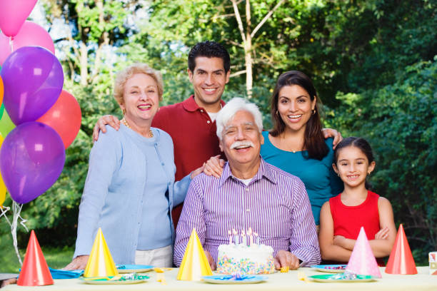 istock Senior Hispanic man with family and birthday cake 1035101032