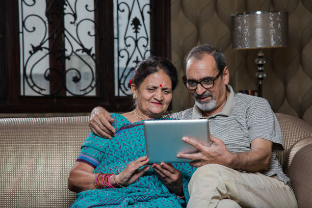 istock Mature couple laughing using a digital tablet - Stock image 1035103796