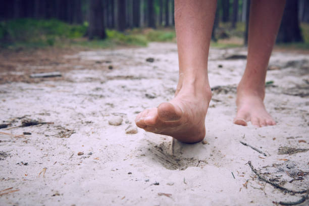 istock Happy barefoot child walk alone by path, explore the forest. 1035103824