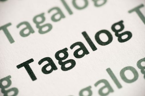word Tagalog language printed on white paper macro