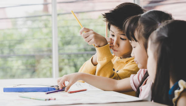 istock Asian children are drawing in kindergarten art classroom 1035108404