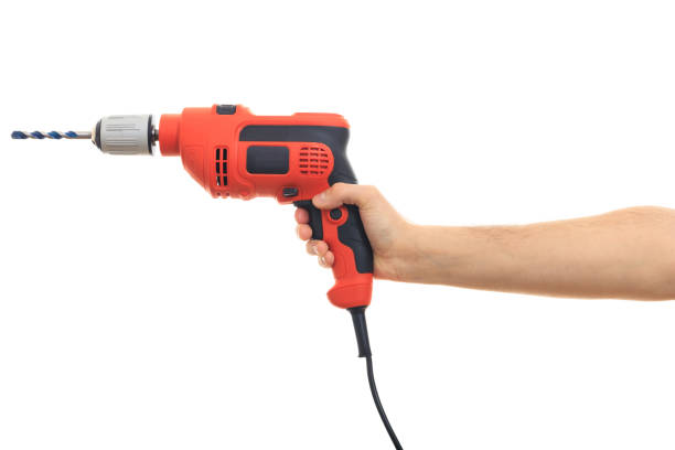 istock Hand holding an electric drill on white background 1035108472