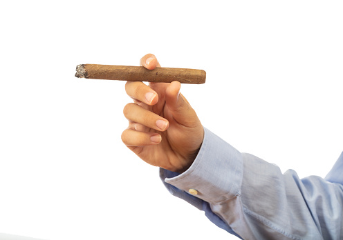 Smoking. Cuban cigar in a male hand isolated on white background, clipping path