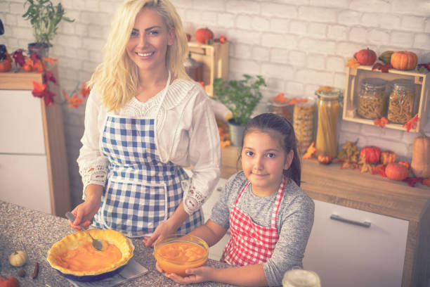 istock Family Preparing Pumpkin Pie 1035114614