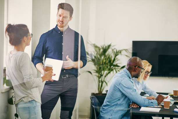 istock Diverse businesspeople talking and working together in an office 1035114686