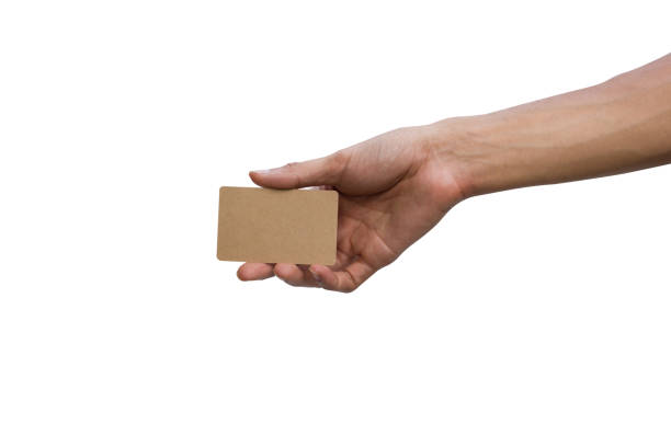 istock Close-up of man hand holding showing empty brown card isolated on white background include clipping path easy for use. 1035115092