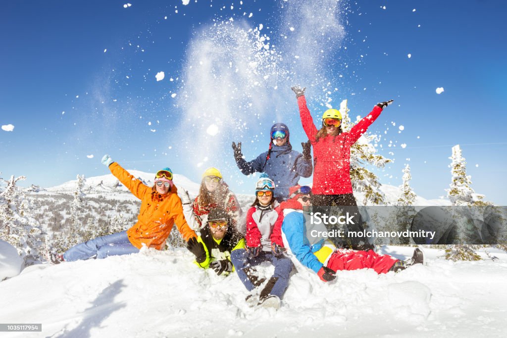 Happy skiers and snowboarders winter vacations Happy skiers and snowboarders having fun at ski resort. Winter vacations concept Skiing Stock Photo