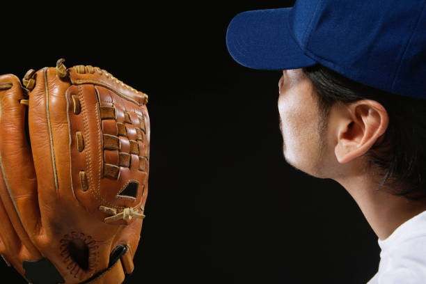 istock Asian man wearing baseball catcher's mitt 1035121174