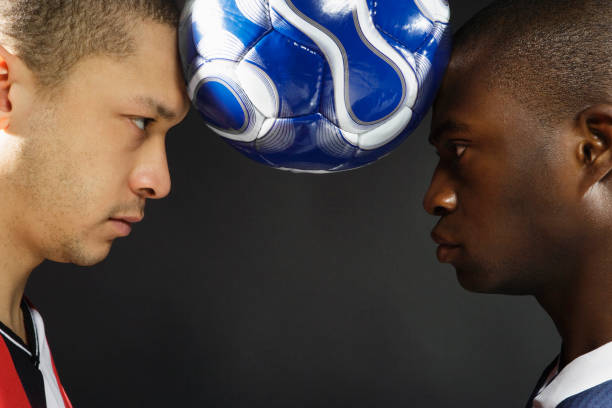 two american football players opposite face to face in dark night with rain. Competition and race concept. High quality photo