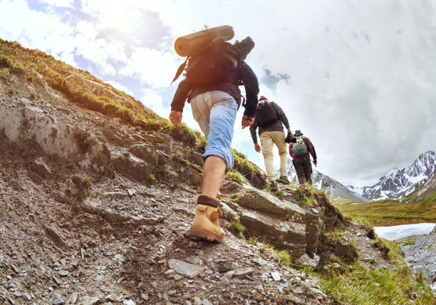 istock Group of tourists walking uphill by trek 1035123584