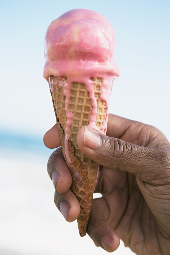 African man holding ice cream cone