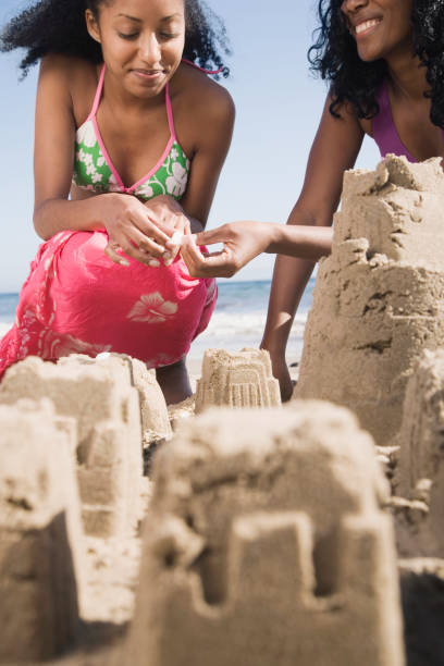 istock African women building sand castles 1035124256