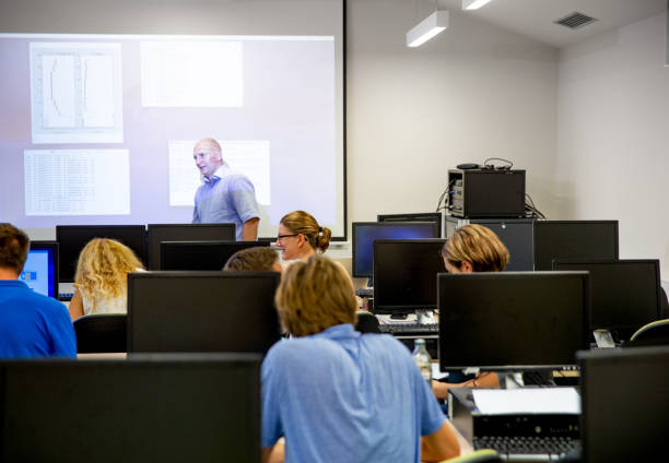 istock Students Listening to Professor in Computer Classroom 1035127194