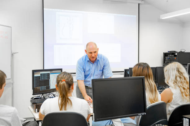 istock Professor Explaining Subject to Adult Students 1035127266