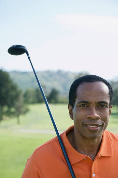 istock African man holding golf club 1035127986