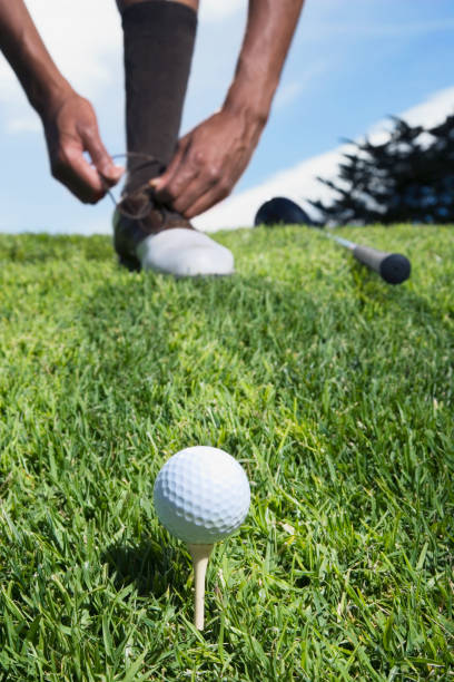 istock African man on golf course tying shoe 1035130808