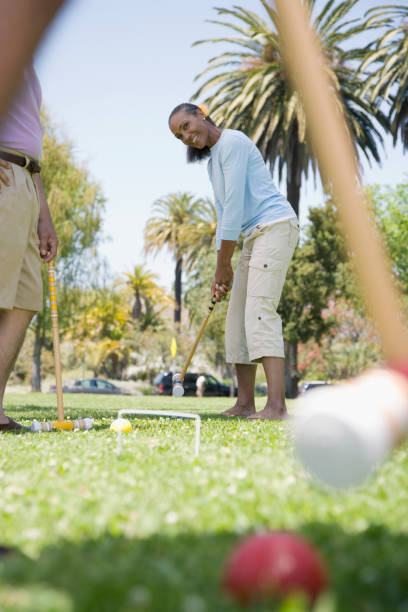 Mixed Race woman playing croquet