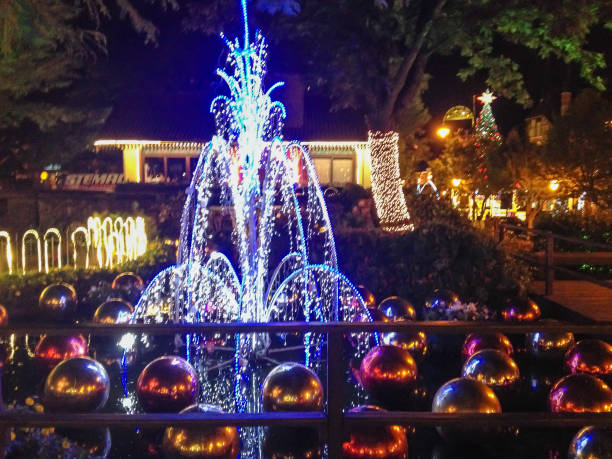 fountain decorated for Christmas in the city of Gramado in Brazil, with colorful balls and many bright lights at night