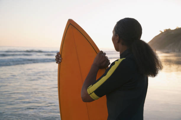 istock Mixed Race woman holding surfboard 1035135816