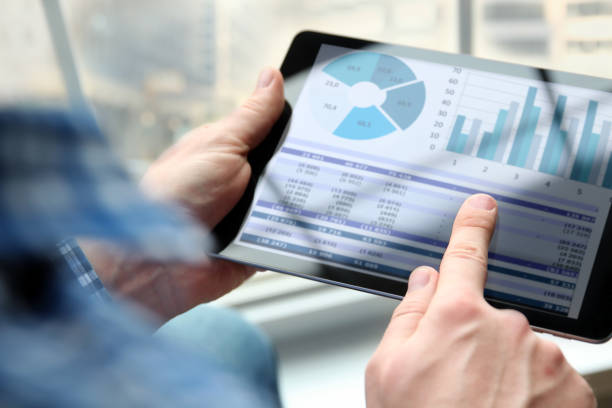 istock Business man working and analyzing financial figures on a graphs on a tablet  in  the office 1035136036