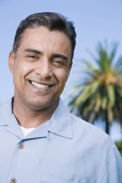 istock Hispanic man in front of palm tree 1035136380