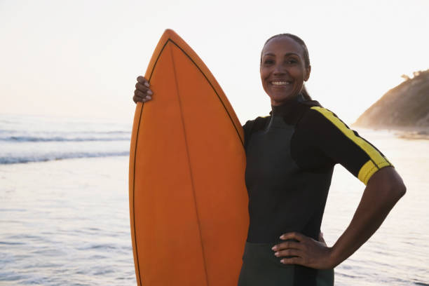 istock Mixed Race woman holding surfboard 1035136414