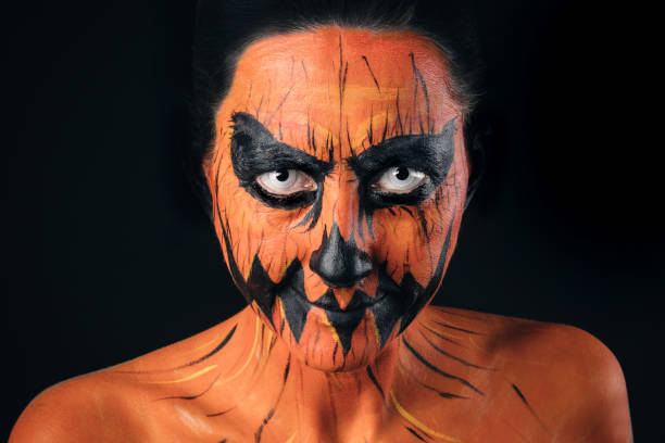 istock Creepy Jack-o'-lantern Make Up on Smiling Woman 1035141550