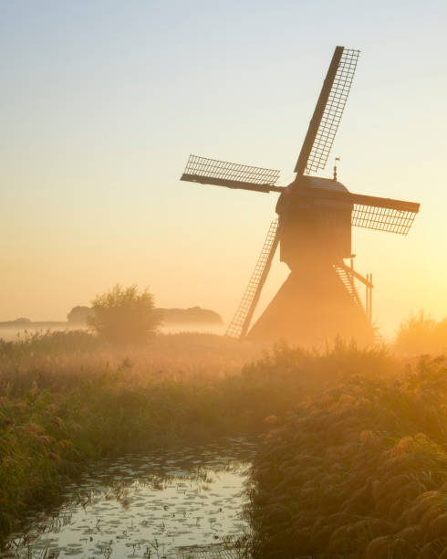 istock Windmill in a beautiful misty sunrise. 1035141666