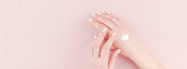 istock Woman moisturizing her hand with cosmetic cream 1035146620