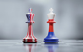 Two King Chess Pieces Textured With American And Russian Flags On Black And White Chessboard