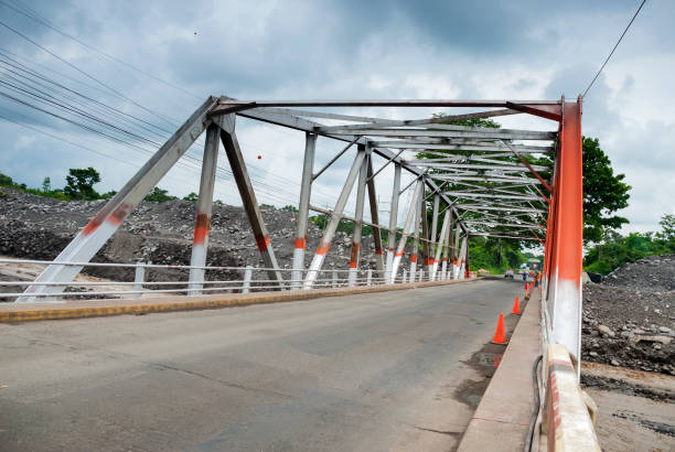 istock Steel bridge and asphalt layer, engineering in Guatemala, Central America, over turbulent river, tropical area. 1035146832
