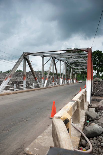 istock Steel bridge and asphalt layer, engineering in Guatemala, Central America, over turbulent river, tropical area. 1035146834