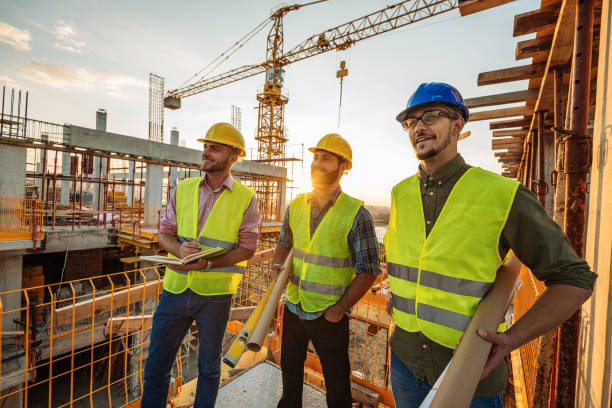 istock Architects and engineers working together in reflective clothing 1035150304