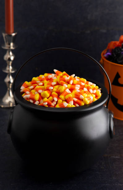 istock Black Cauldron For Witches FIlled with Candy Corn 1035150510