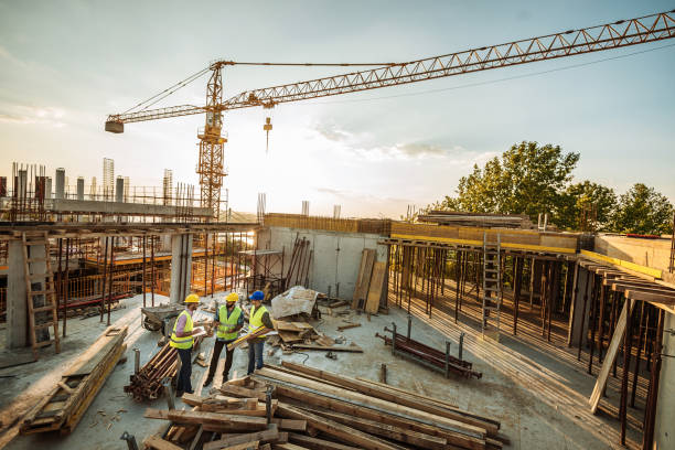 istock Group of engineers and professionals having meeting on the construction site 1035150688