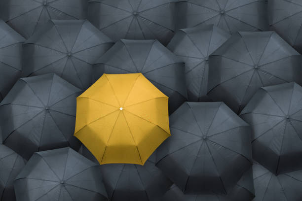 istock Yellow umbrella stand out from the crowd. Leader concept. 1035153342