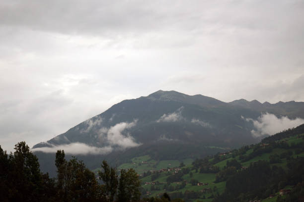 Mountains in the fog photographed on a pass road in Austria in autumn