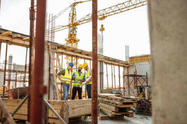istock Construction industry - architects and engineers on business meeting on construction site 1035156922