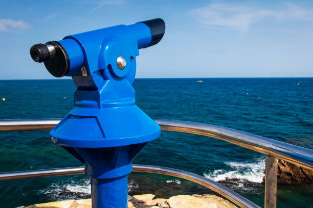 istock Binoculars on viewing platform on seafront in Lloret de Mar, Costa Brava, Catalonia, Spain. Mint binoculars on sea viewpoint. Telescope overlooking sea in Lloret de Mar. Catalonia, Spain, Europe 1035161416