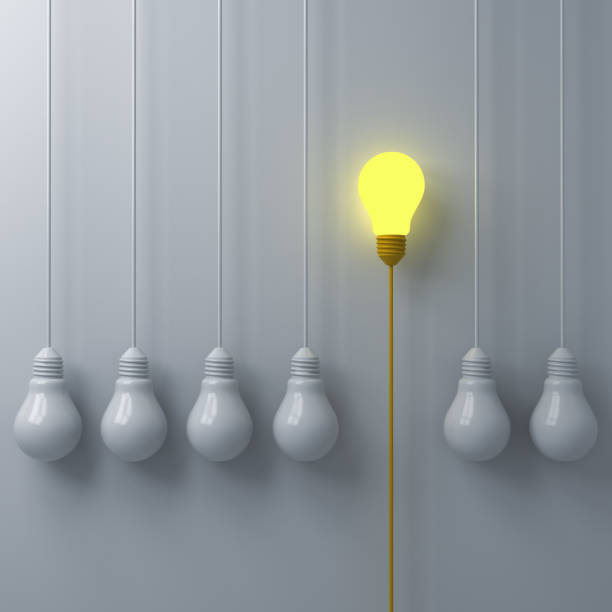 istock Think different concept One glowing light bulb standing out from the dim or unlit white lightbulbs on white wall background with shadows leadership and individuality creative idea concept 3D rendering 1035165048